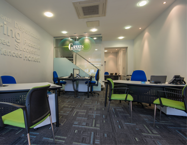 room with chairs and desks with stair case 